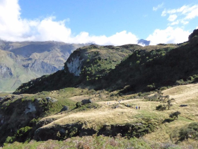 Walkers dwarfed by Mt Aspiring National Park vista